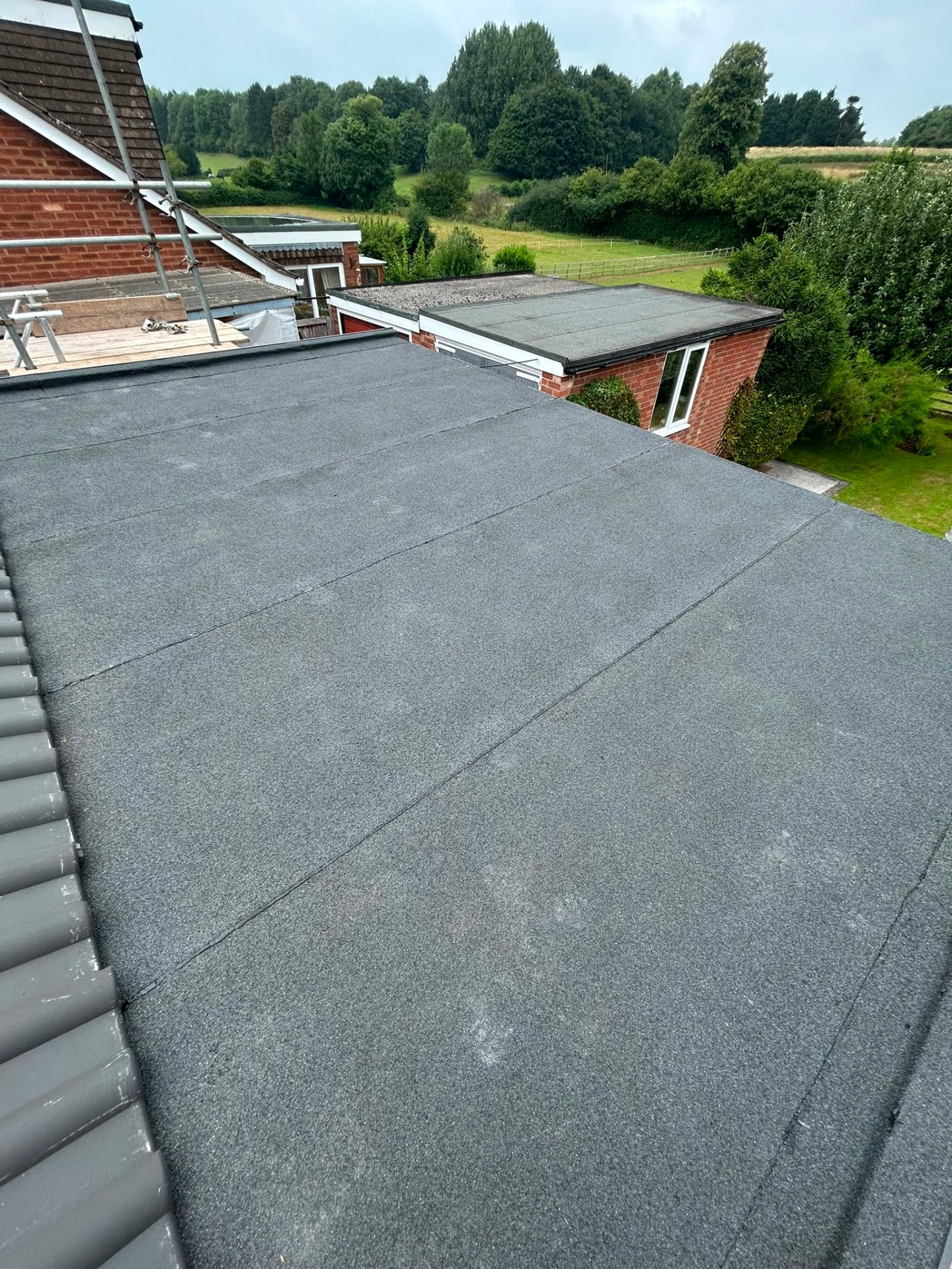 Existing felt flat roof on a domestic outbuilding awaiting replacement