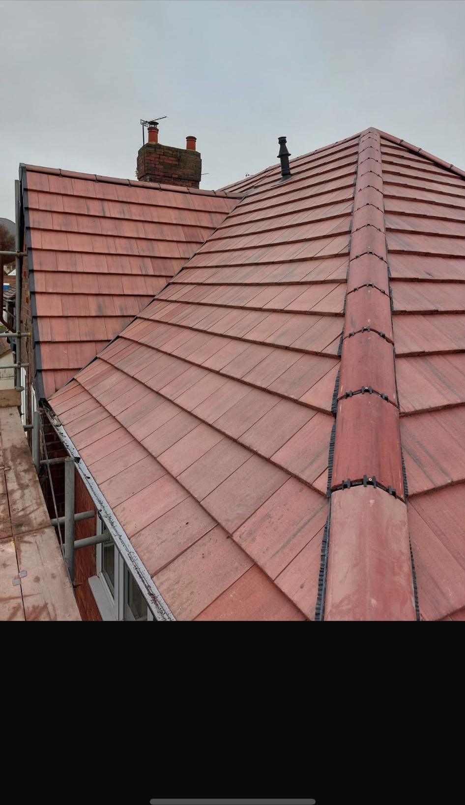 New red clay tile roof with prominent ridge and hip finish, Warwickshire
