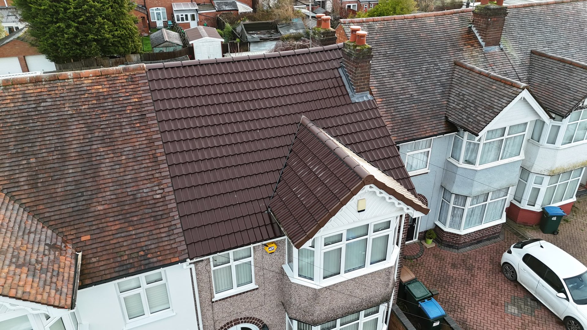 Freshly laid brown concrete tile roof on a Coventry semi-detached home, drone view