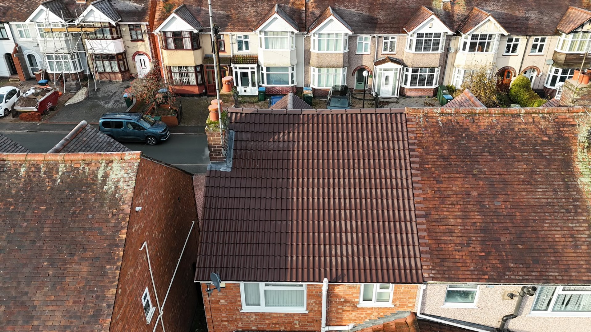 New dark brown tiled roof after full replacement on a Coventry terraced house