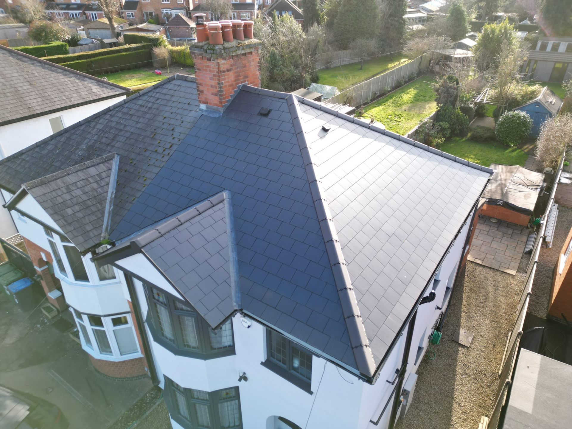 Newly installed grey slate pitched roof on a detached Coventry home
