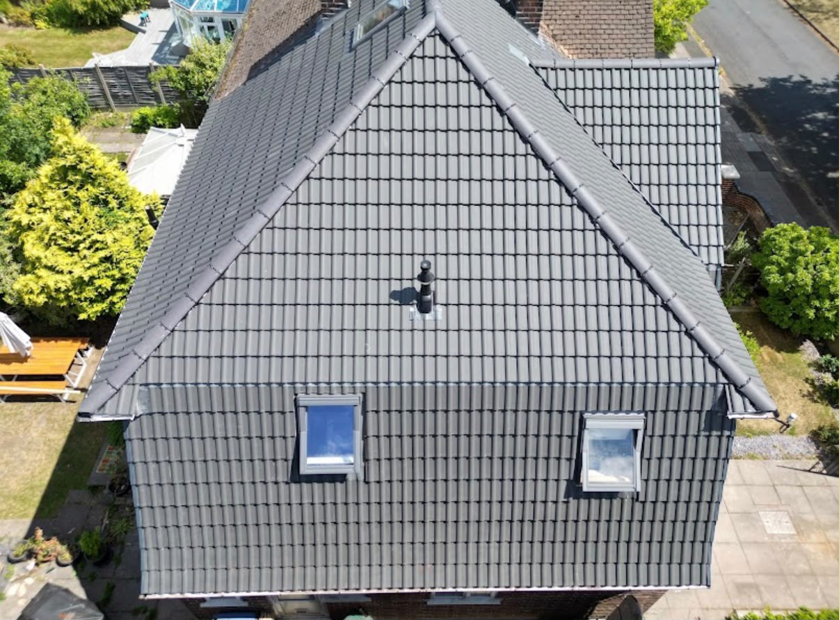 Newly replaced dark grey tiled roof after storm damage repair, West Midlands